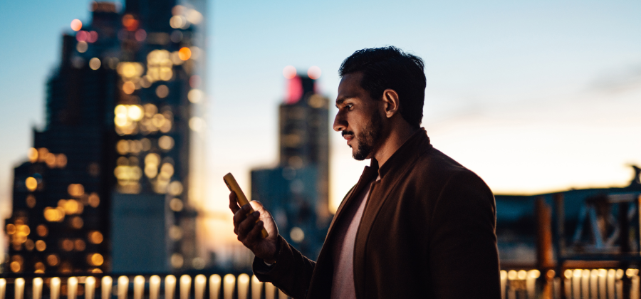 Man on cellphone in city at night
