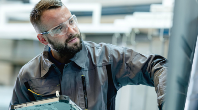 Engineer holding tablet in factory