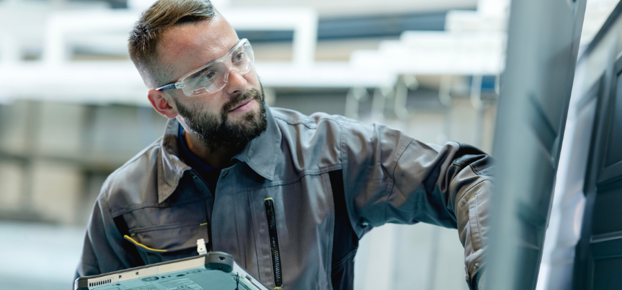 Engineer holding tablet in factory