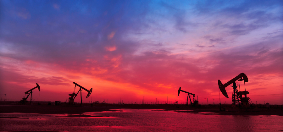 Oil and gas wells at sunset