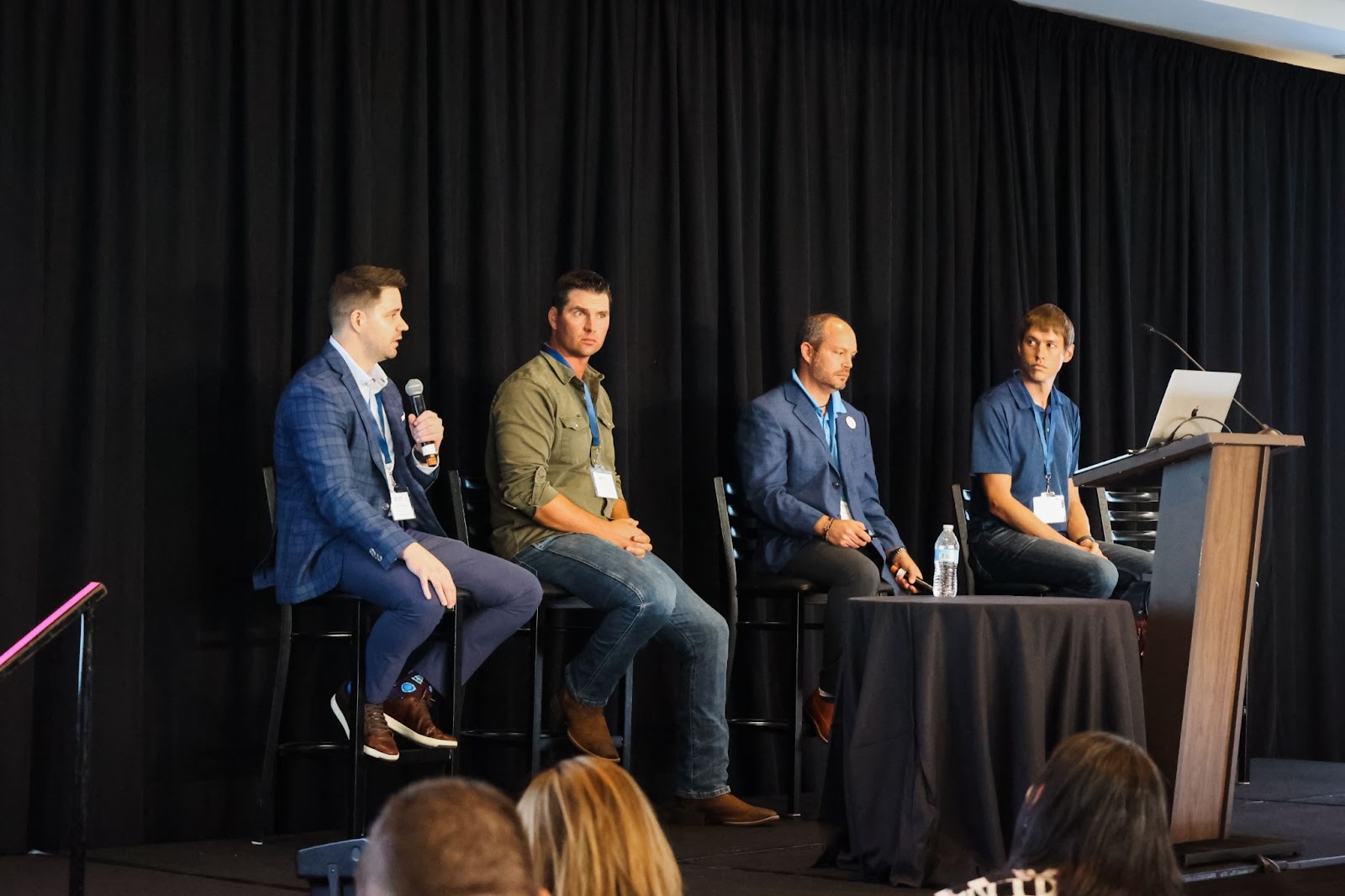 4 men sitting on stage