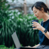 Women sitting in garden with laptop