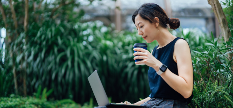 Women sitting in garden with laptop