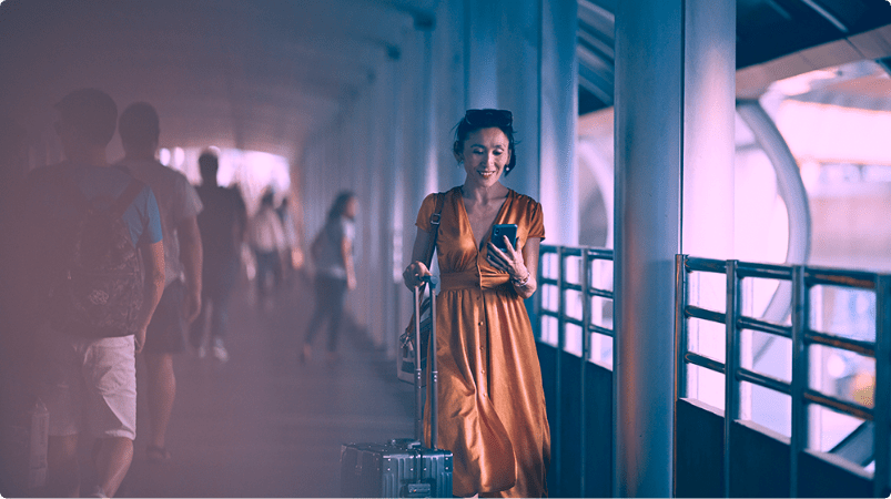 Women with luggage on phone